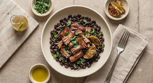 Carnitas & Black Beans — Slow pork carnitas, black beans, charred lime, cilantro.