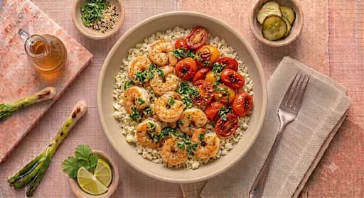 Lemon Pepper Shrimp — Cauliflower rice, blistered tomatoes, herb gremolata.