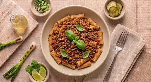 Lentil Bolognese & Whole-Grain Rigatoni — Lentil bolognese, whole-grain rigatoni, basil, cracked pepper.