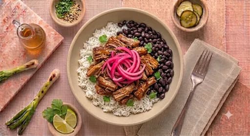 Slow-Braised Carnitas Bowl — Slow-braised carnitas, white jasmine rice, black beans, pickled red onion.