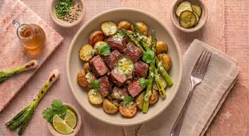 Steak Bites & Potatoes — Roasted potatoes, asparagus, garlic herb butter.