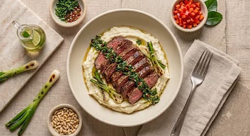 Steak & Chimichurri Cauliflower Mash — Seared steak, whipped cauliflower, chimichurri, charred scallion.